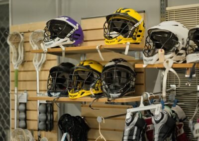 lacrosse helmets and equipment on shelves